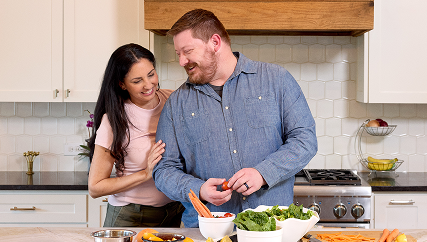 Couple cooking together in a kitchen.