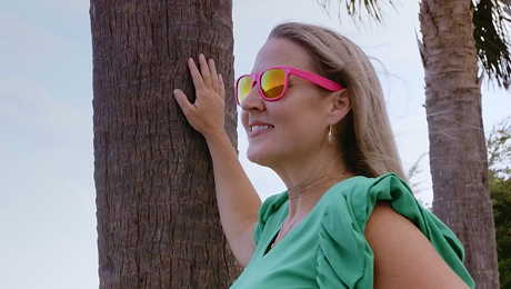 Woman smiling while outdoors.