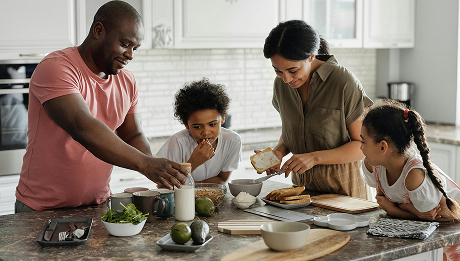 Family cooking together in kitchen.